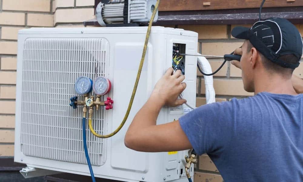 A technician checking the AC refrigerant outer