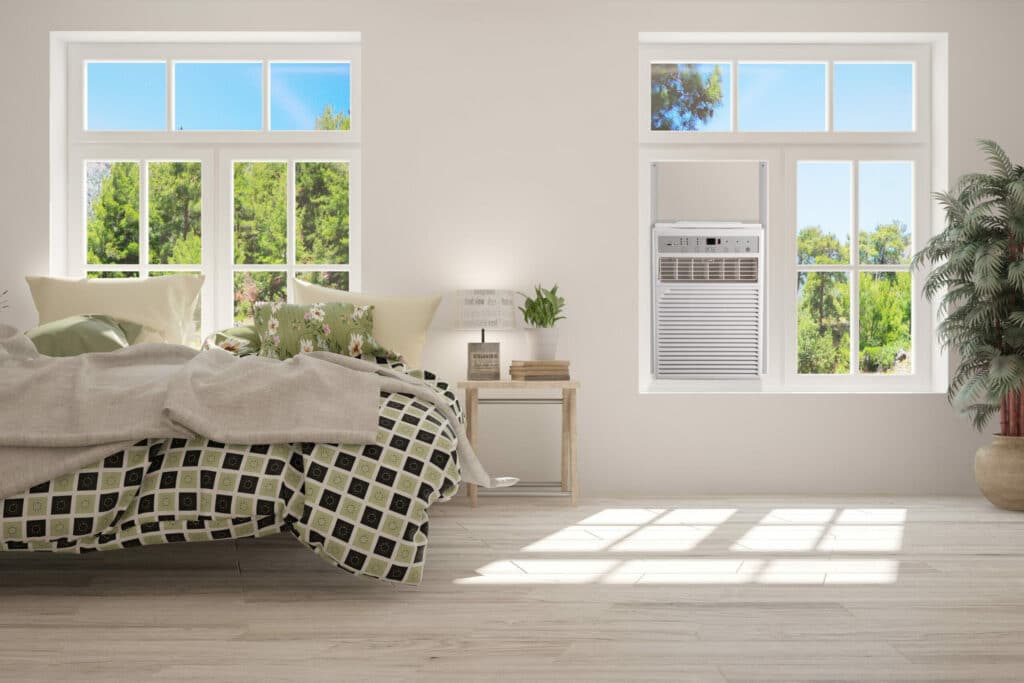 A view of a sunlit bedroom with an AC in a casement window installed