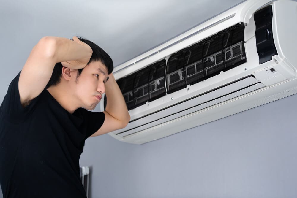 a person is getting annoyed by a banging sound of AC