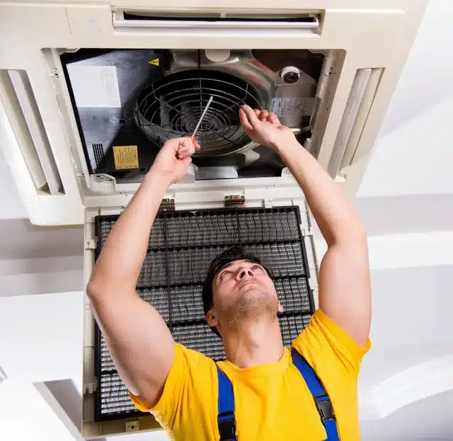 A view of a technician fixing an ac