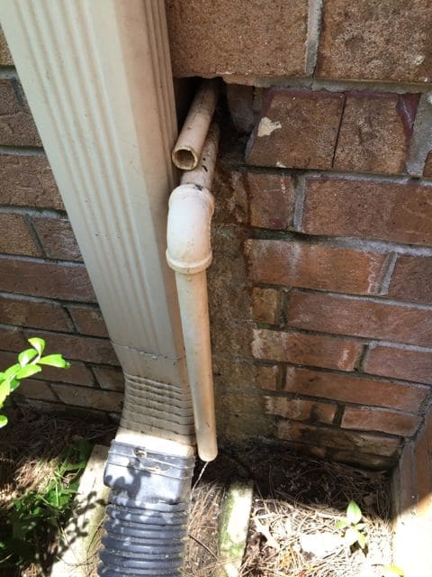 A view of an ac condensate drain pipe outdoors