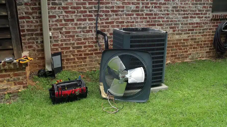 A view of an outer of an air conditioner outside a home backyard