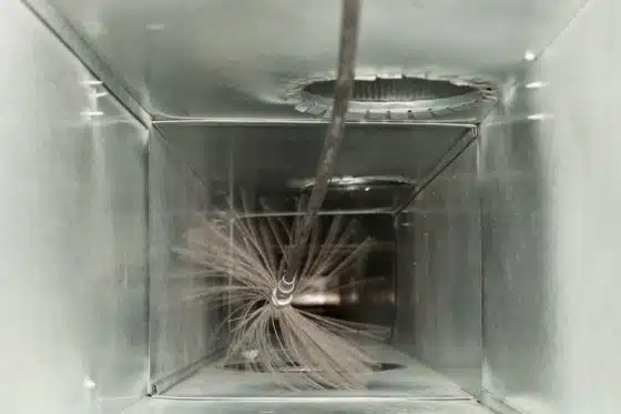 An inside view of an ac air duct being cleaned up