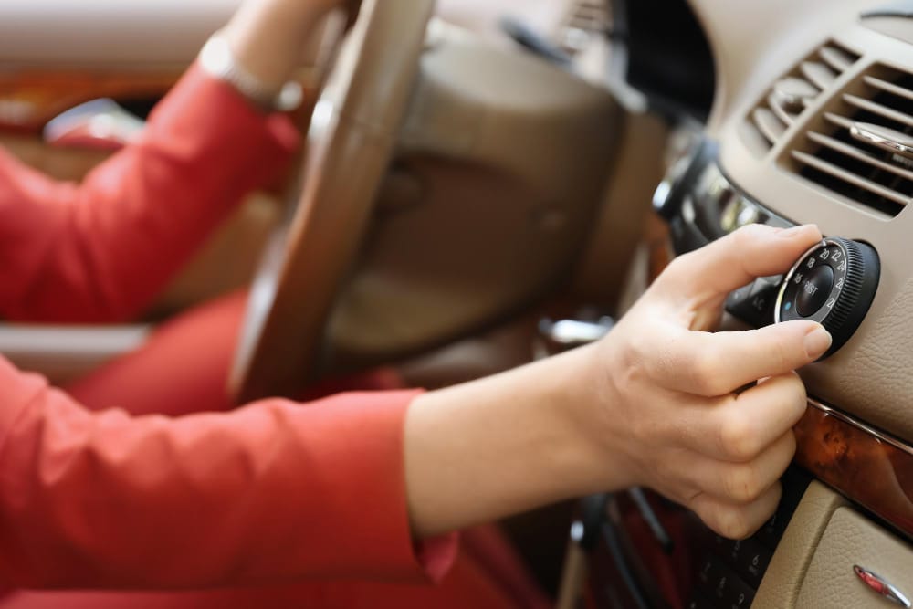 A view of a person changing the settings of a car ac