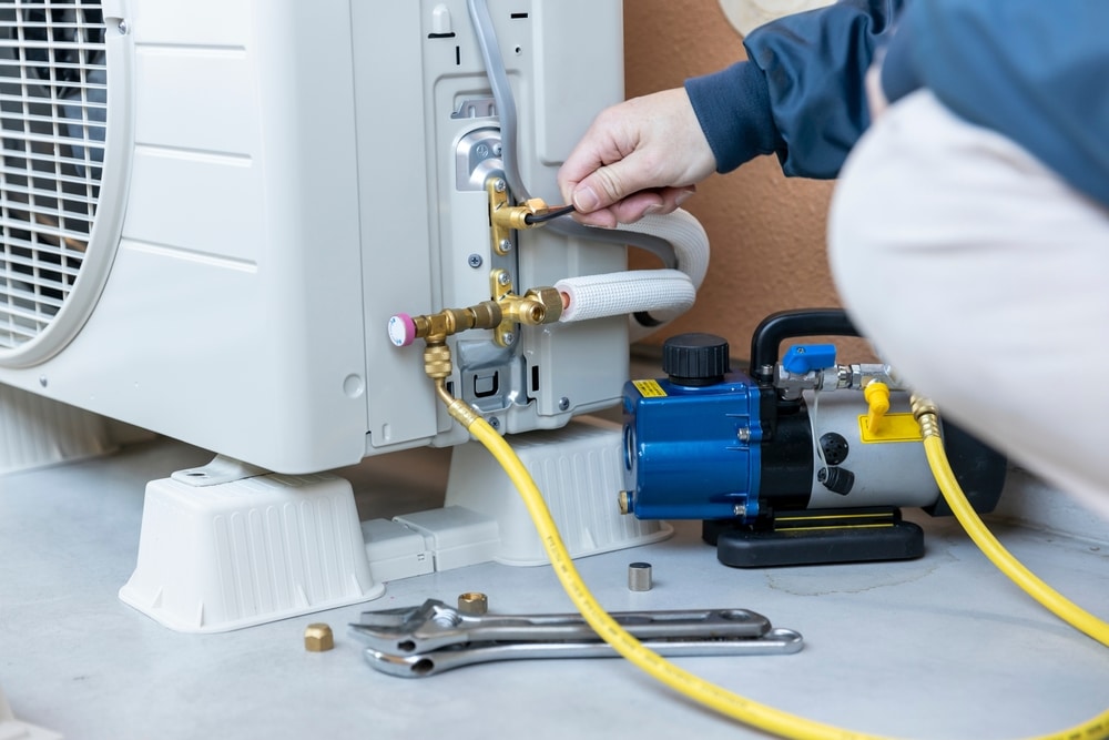 A view of a person installing the ac hose pipe