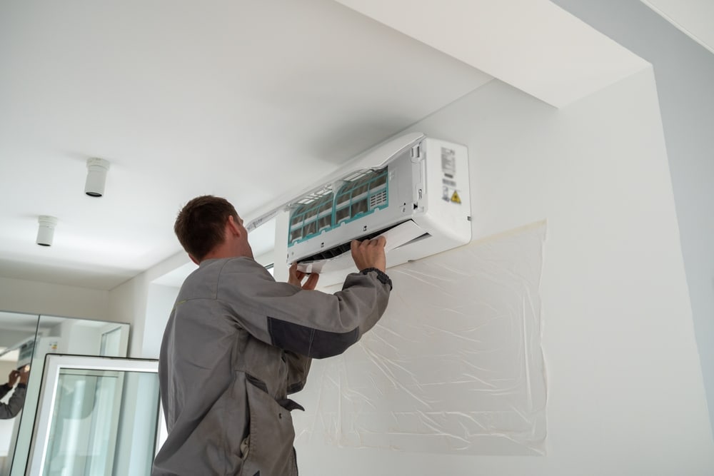 A view of a technician fixing an ac system