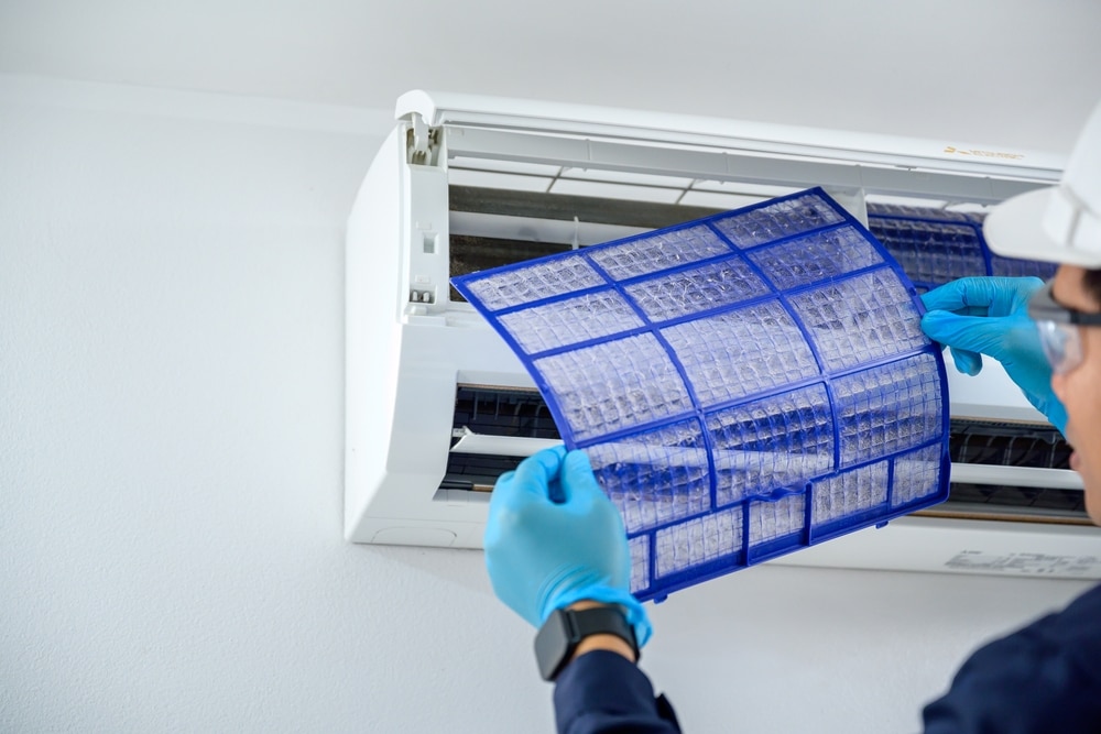 A view of a person holding an ac filter