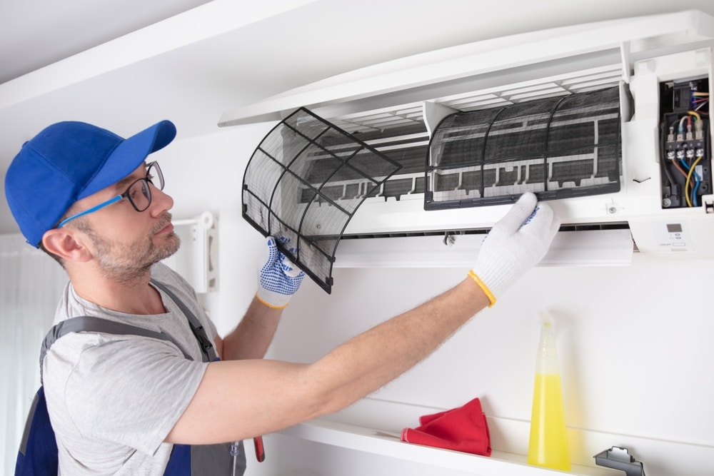 A view of a professional checking ac filter